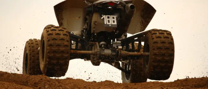ATV coming over a dirt hill