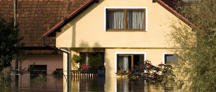 Home exterior with flood waters covering half of the first story
