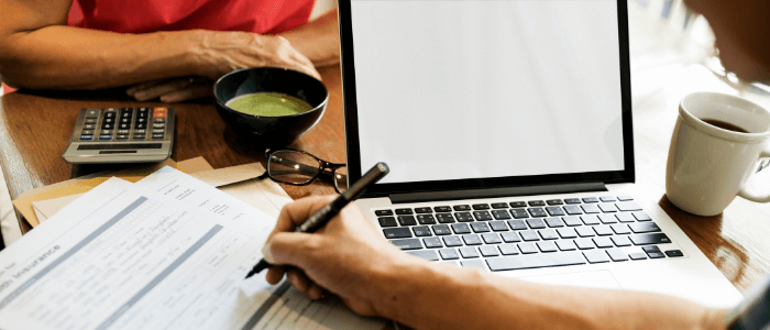 Couple sitting at a table filling out an insurance application